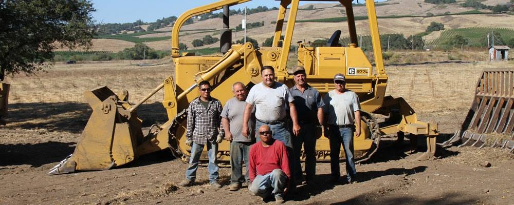 Vic Chiapetta General Engineering crew with a Caterpillar track loader